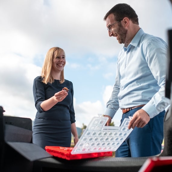 A man and a woman are showing components