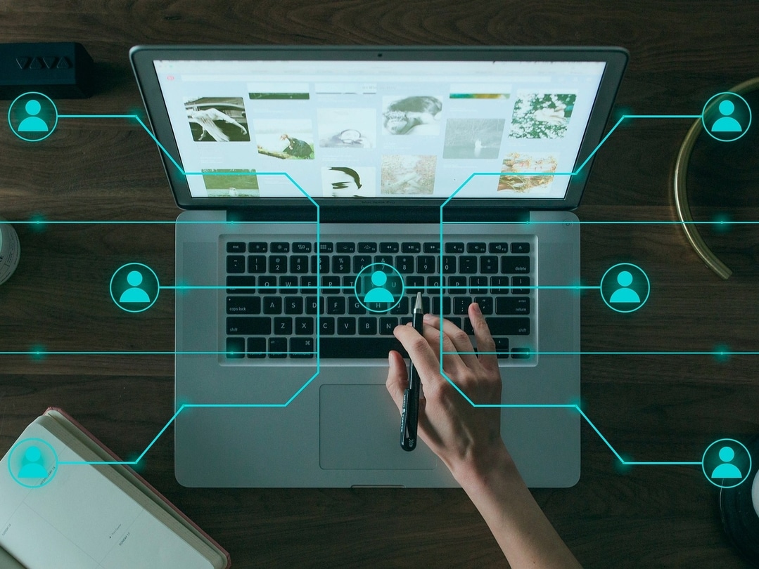 Computer with icons of a person connected with lines