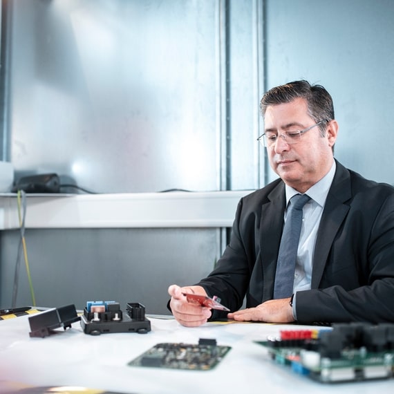 Technical developer in the lab works with circuit boards and boards