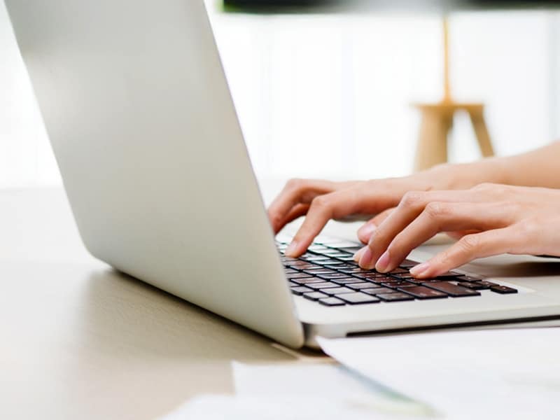 Laptop on screen with tipping hands