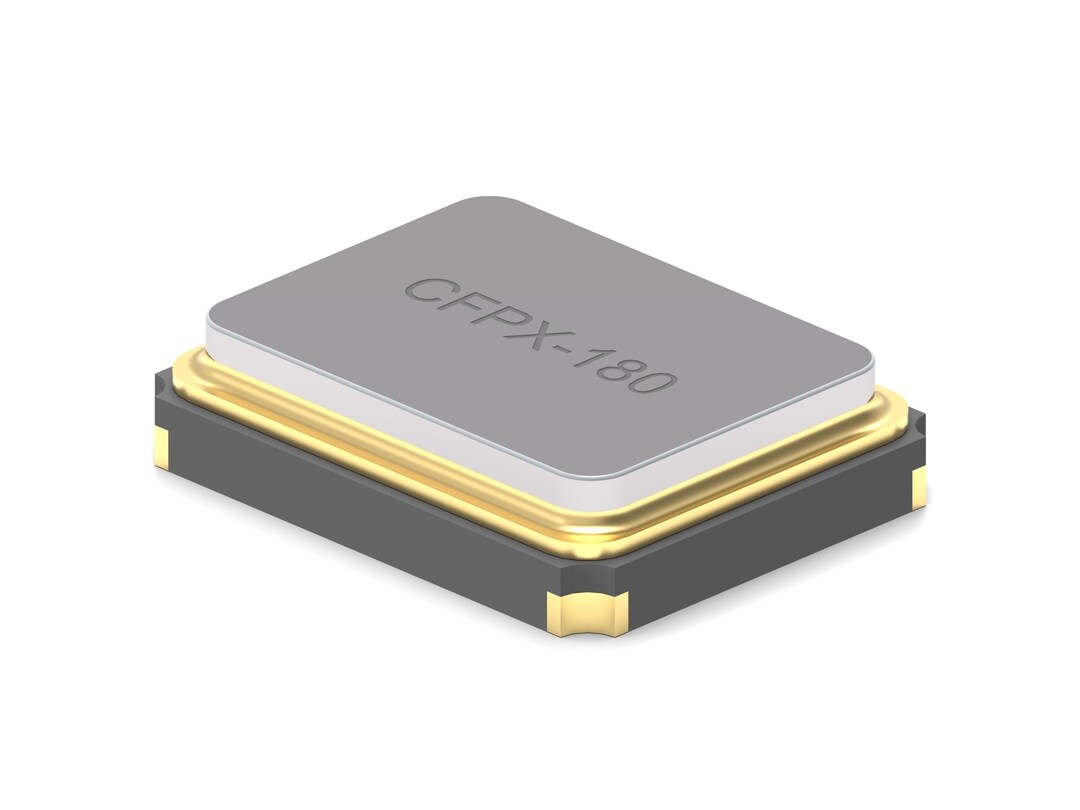 a gray-silver, almost cuboid-shaped component lies on a white background. On it you can see a lettering