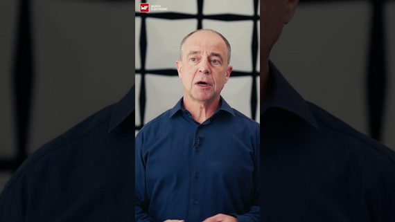 yt_img_for_code_ol0tSDoZEmA.jpg A man with a blue shirt stands in front of a wall in an EMC lab