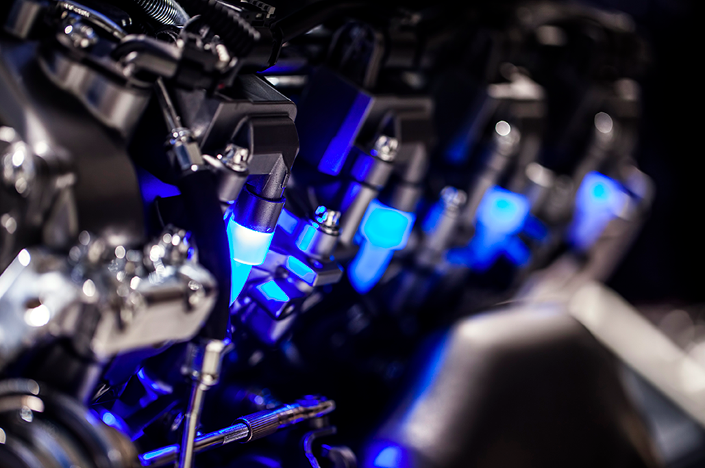 Automotive Applications Electrification Blue glowing parts inside the engine bay of a car