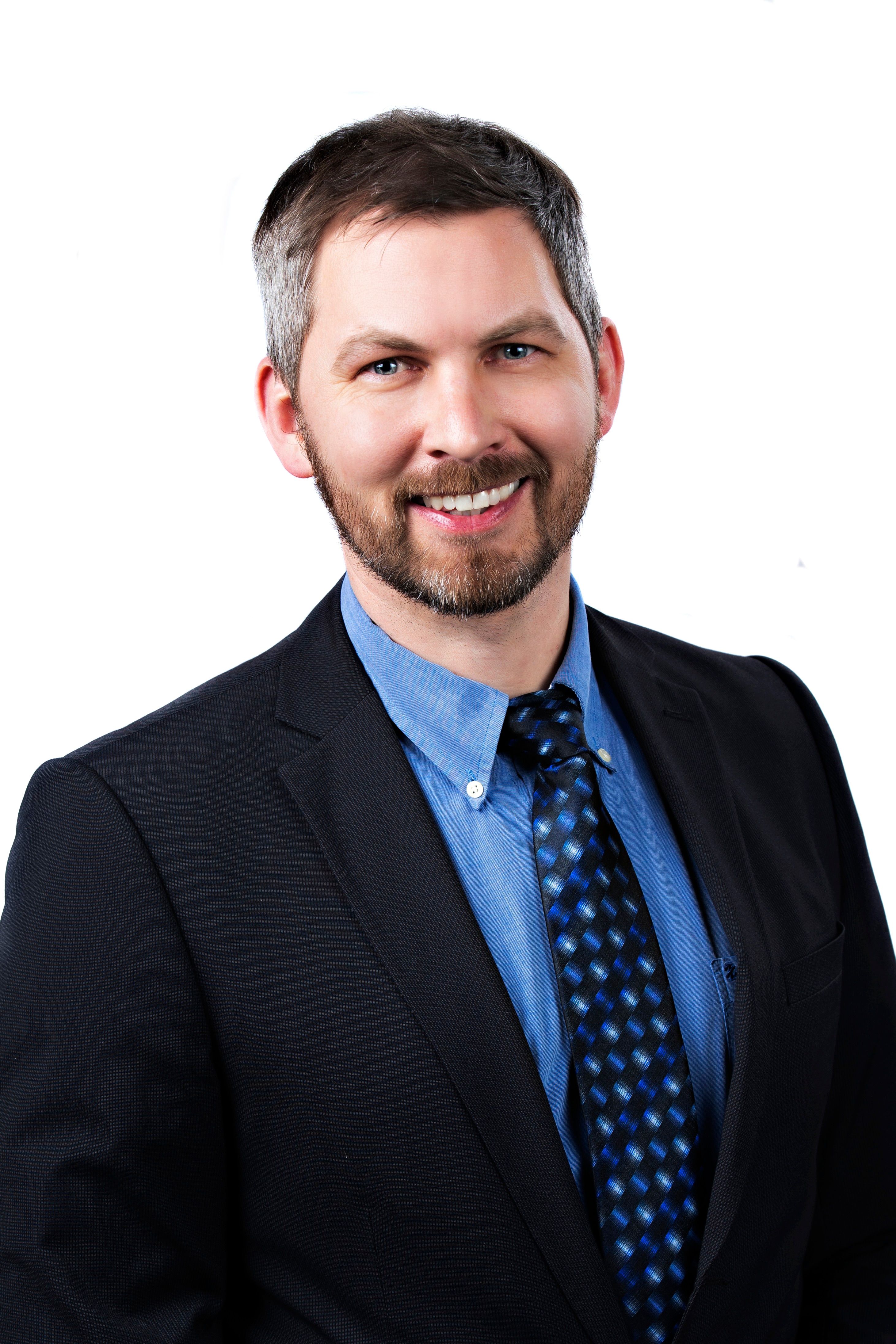 Diversity / Holger A Man is sitting in front of a wise wall and is smiling at camera